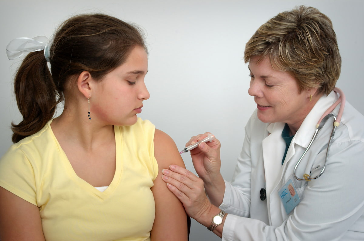 woman getting a flu vaccination at a pharmacy near me in Bebington